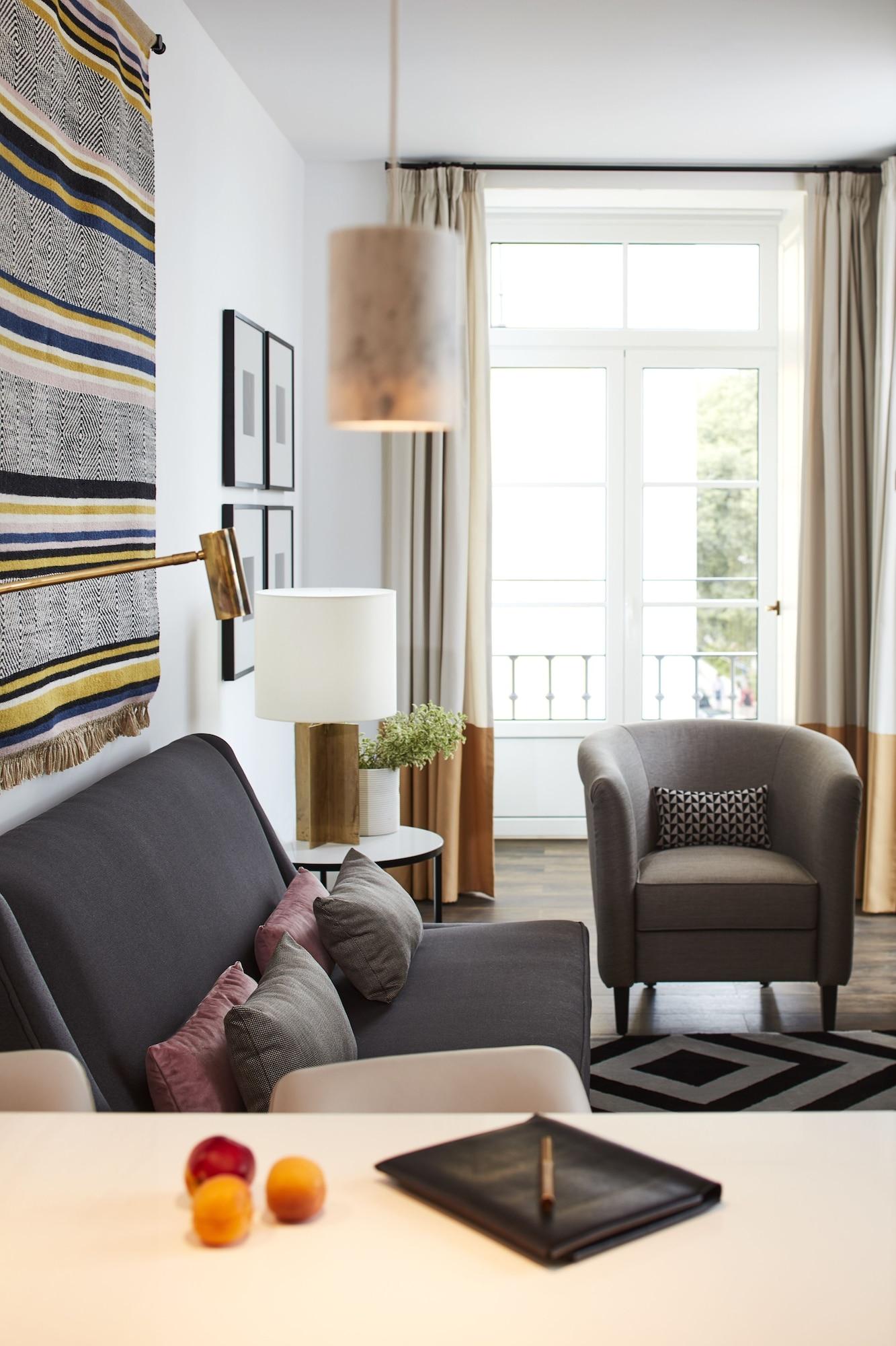 The Lumiares Hotel & Spa - Small Luxury Hotels Of The World Lisbona Esterno foto A living room with a sofa, armchair, and floor lamp